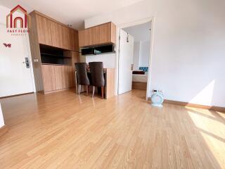 Bright living area with wooden flooring and dining space