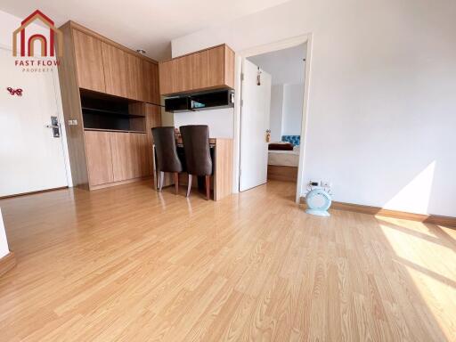 Bright living area with wooden flooring and dining space