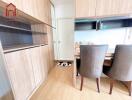 Modern dining area with wooden furnishings and storage