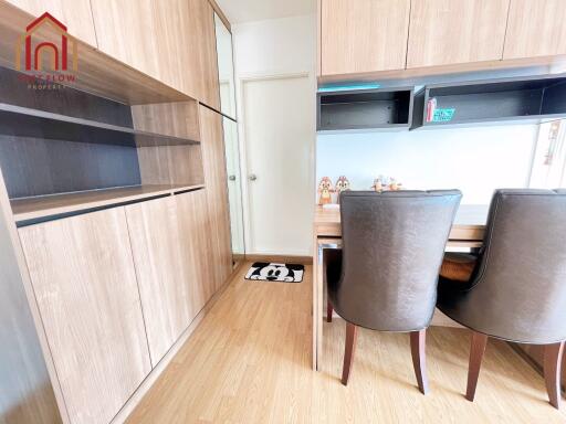 Modern dining area with wooden furnishings and storage