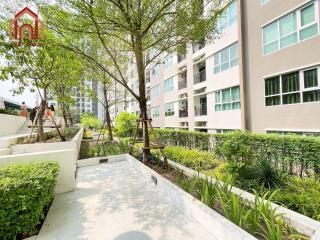 Modern residential building with outdoor walkway and greenery