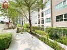 Modern residential building with outdoor walkway and greenery