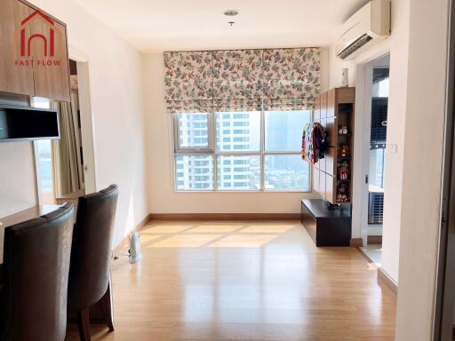 Bright living room with large windows and hardwood floors