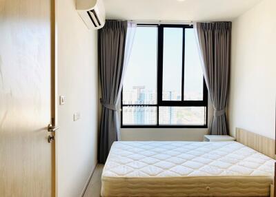 Bedroom with large window and city view