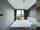 Modern bedroom with large window and city view