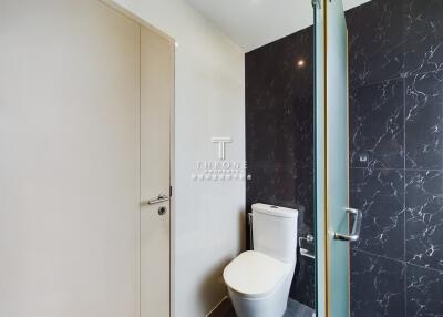 Modern bathroom with glass shower door and tiled walls