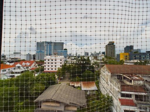 High-rise building view from a netted window