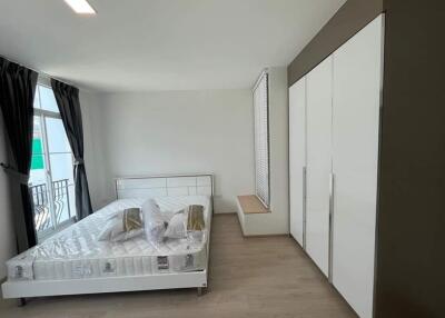 Modern bedroom with large windows and built-in wardrobe