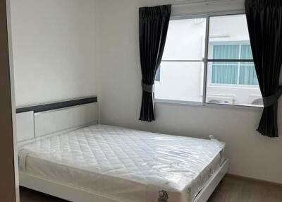 Modern bedroom with window, AC unit, and bed