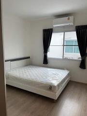 Modern bedroom with window, AC unit, and bed