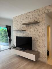 Modern living room with TV and marble accent wall