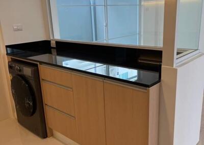 Modern kitchen with wooden cabinets and a built-in washer