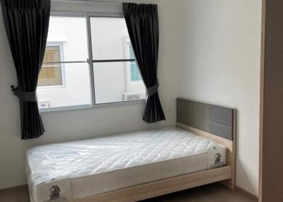 Small bedroom with single bed and air conditioner