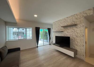 Modern living room with TV and patio access