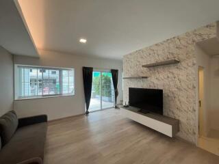 Modern living room with TV and patio access