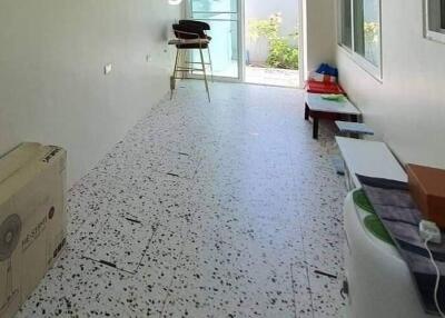 Long narrow room with terrazzo flooring and window