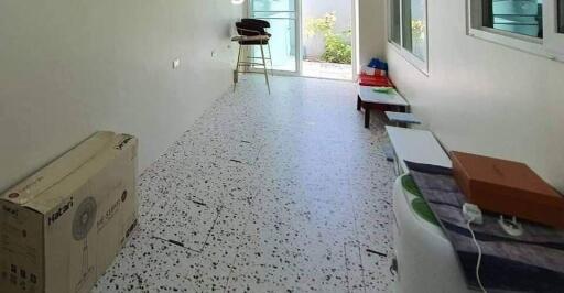 Long narrow room with terrazzo flooring and window