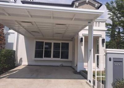 Front view of a residential building with a carport