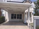 Front view of a residential building with a carport