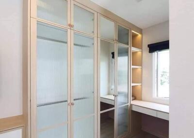 Modern bedroom with built-in wardrobe and study desk