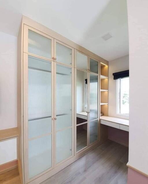 Modern bedroom with built-in wardrobe and study desk