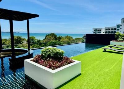 Rooftop pool with seating area and sea view