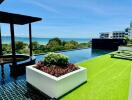 Rooftop pool with seating area and sea view