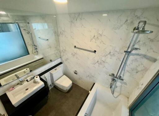 Modern bathroom with marble walls and fixtures