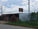 Roadside building with outdoor structures and banana plants