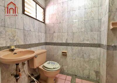 Bathroom featuring a wall-mounted sink and a toilet