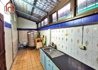 Clean kitchen with tiled walls and ceiling windows