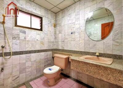 Spacious bathroom with large mirror and tiled walls