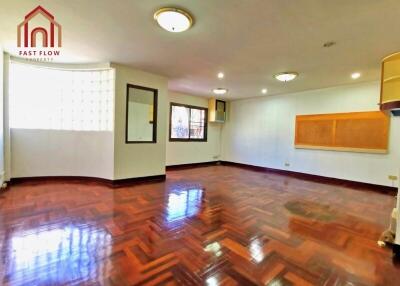 Spacious living room with wooden flooring and bright natural light