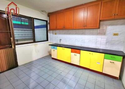 Colorful kitchen with tiled floor and wooden cabinets