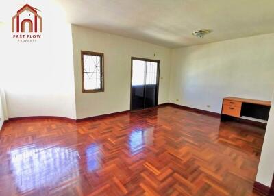 Spacious living room with hardwood floors and desk