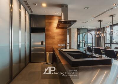 Modern kitchen with stainless steel appliances and wooden accents