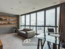 Spacious living room with large windows and city view