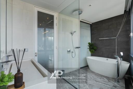 Modern bathroom with glass-enclosed shower and freestanding bathtub