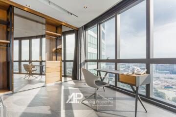 Modern home office with large windows and urban view