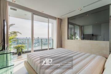 Modern bedroom with large windows and balcony view