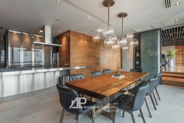 Modern dining room with wooden table and hanging light fixtures