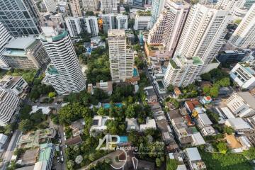 Aerial view of a residential area with tall buildings and green spaces