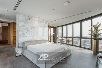 Modern bedroom with large windows and city view