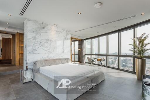 Modern bedroom with large windows and city view