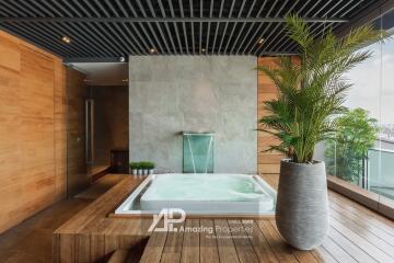 Modern luxurious bathroom with jacuzzi and indoor plants