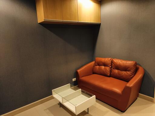 cozy living room with brown sofa and white coffee table