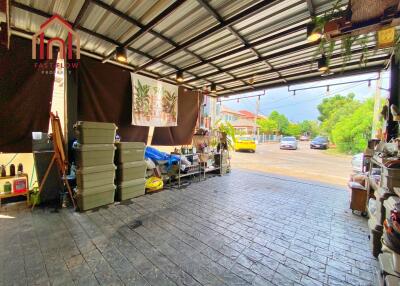 Spacious garage with organized storage and view of the street outside