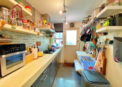 Modern well-stocked kitchen with various appliances and accessories