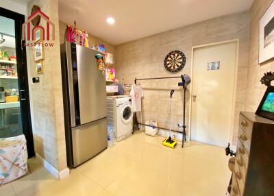 Utility room with modern appliances and storage space