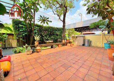 Outdoor patio area with terracotta tiles and potted plants